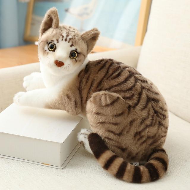 Cat plush toy in a lying prone pose
