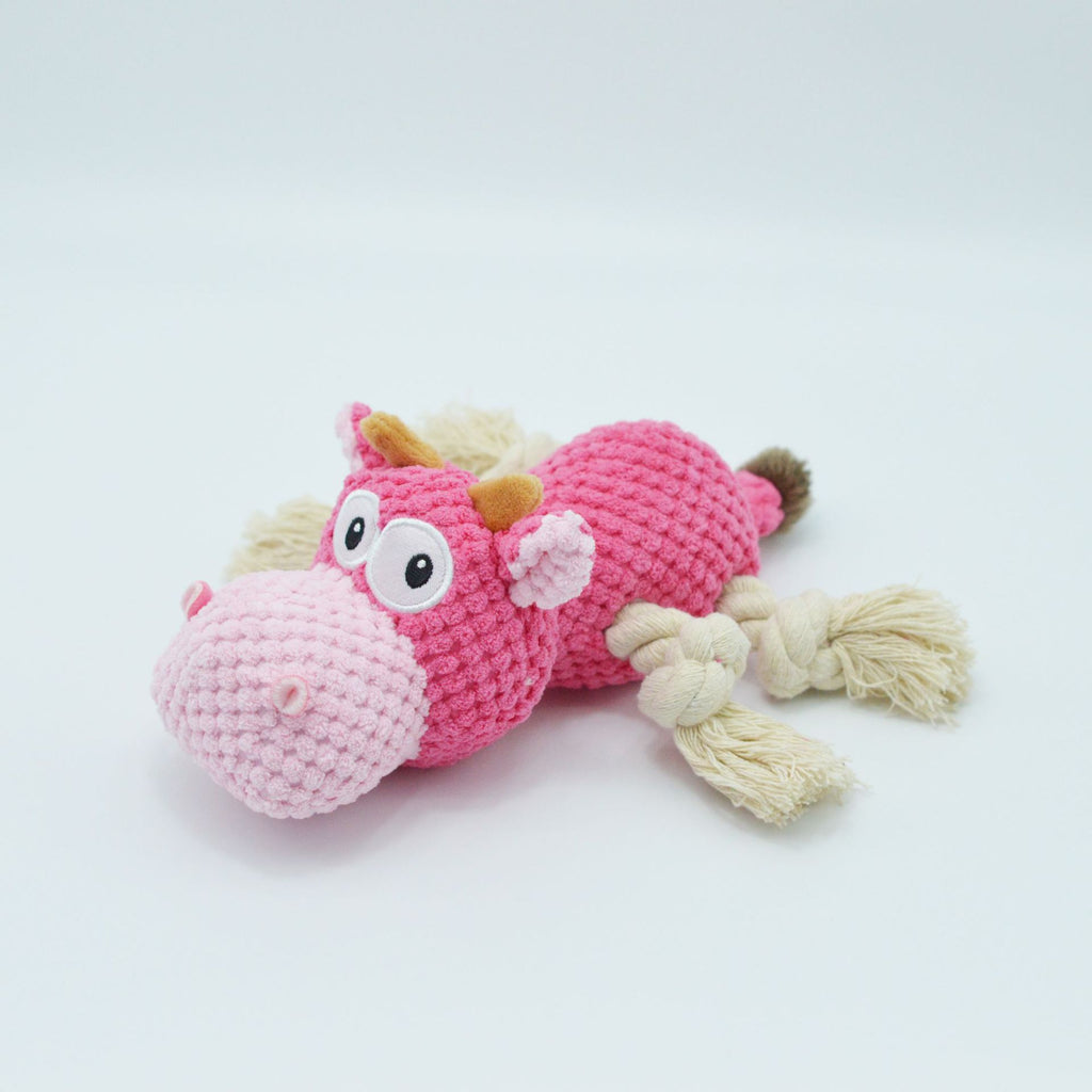 Dog chewing on plush squeaky toy