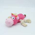 Dog chewing on plush squeaky toy