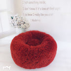 Round plush pet bed displayed empty
