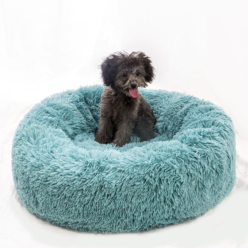 Round plush pet bed shown in a room setting
