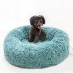 Round plush pet bed shown in a room setting
