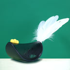 Swinging chicken cat treat toy, close-up of feather tail